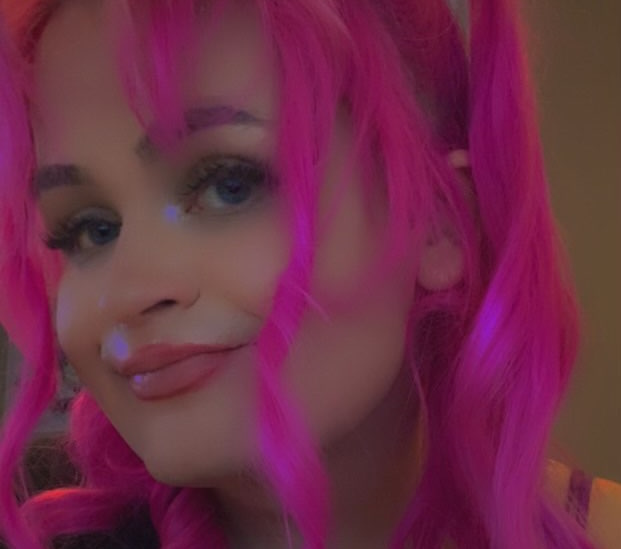 a picture of me smiling towards the camera with pink hair